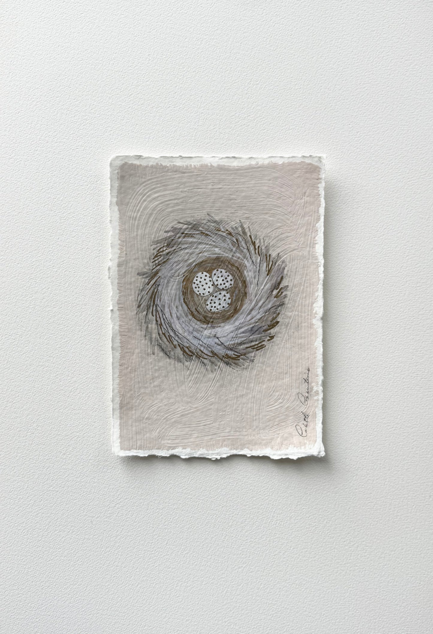 Painting of eggs in a nest on handmade paper