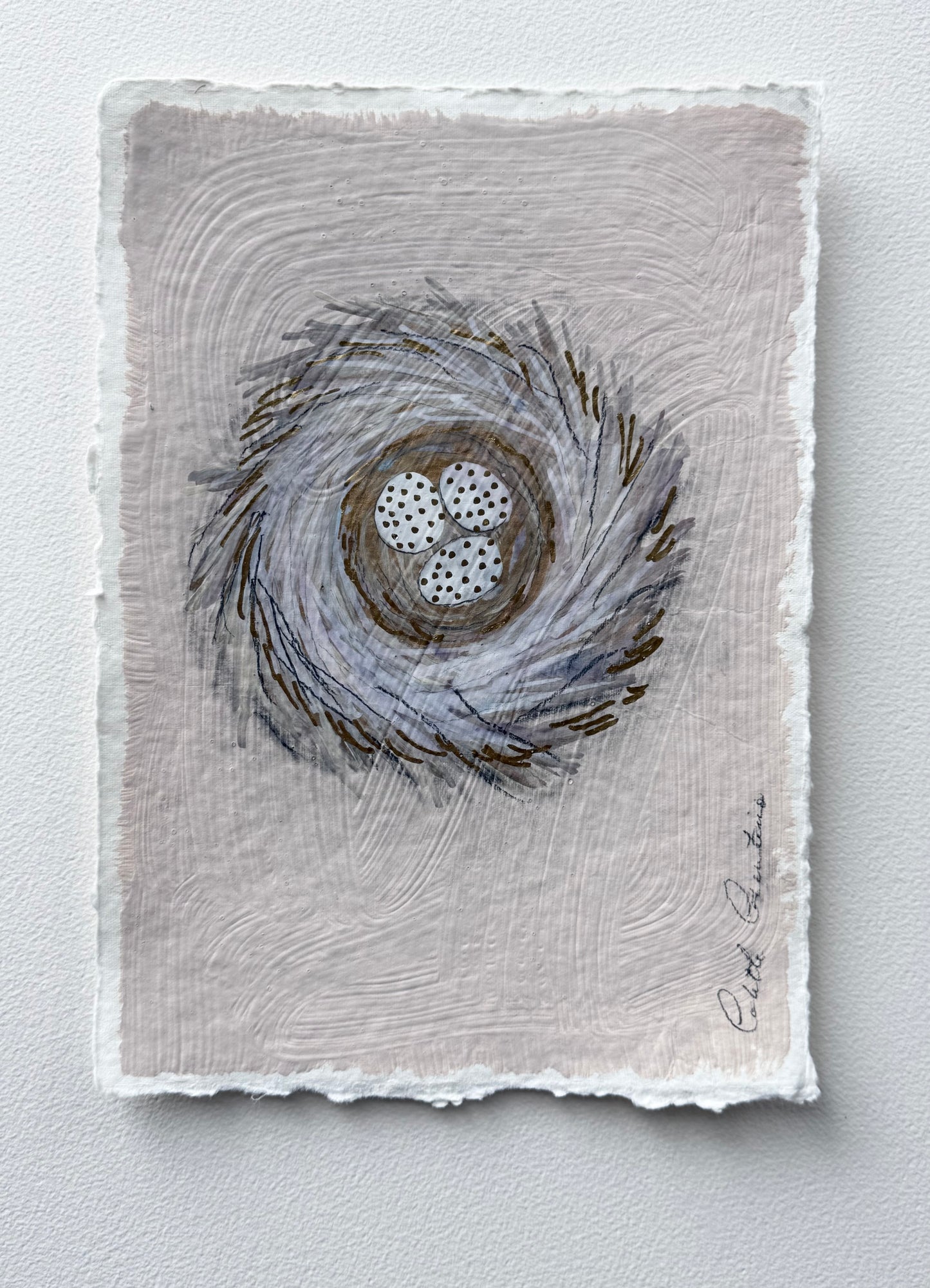 Painting of eggs in a nest on handmade paper
