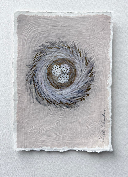 Painting of eggs in a nest on handmade paper